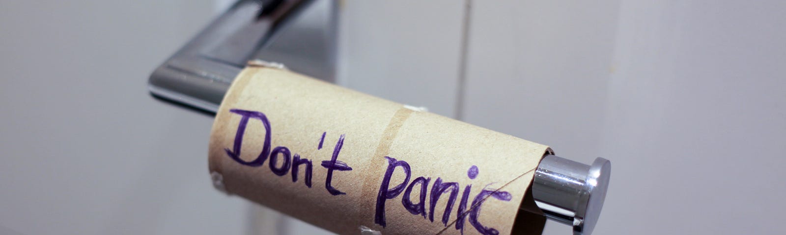 An empty roll of toilet paper with the message “Don’t panic.”