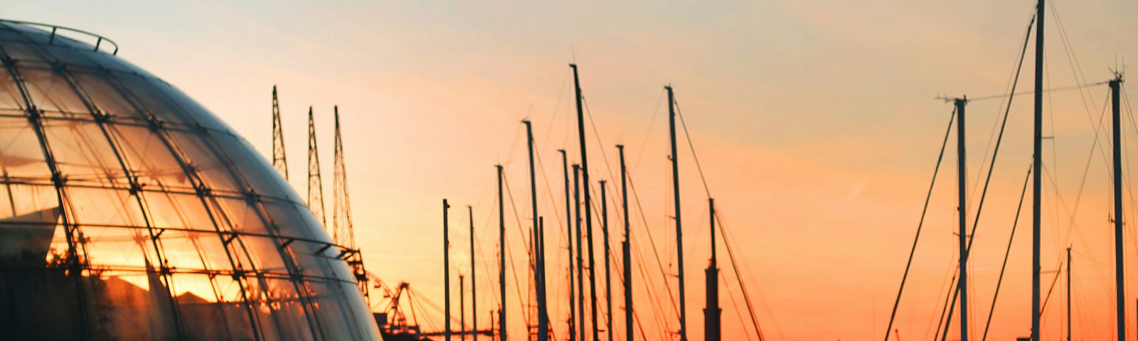 a picture of boats at a marina during sunset- you can see darker shadows in the light