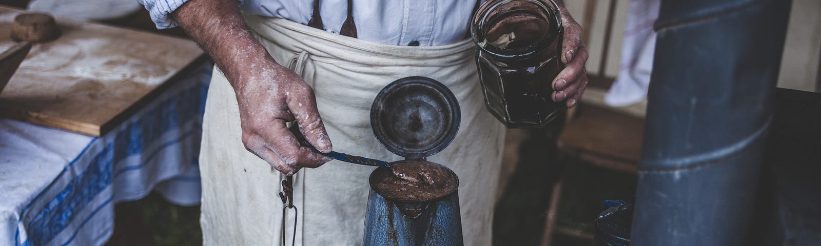 Craftsman making coffee on an old stove for article by Larry G. Maguire