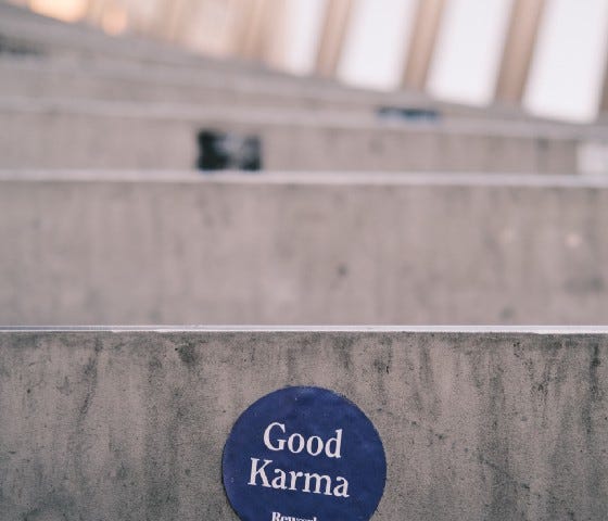 concrete steps with a blue circle written on it that says Good Karma