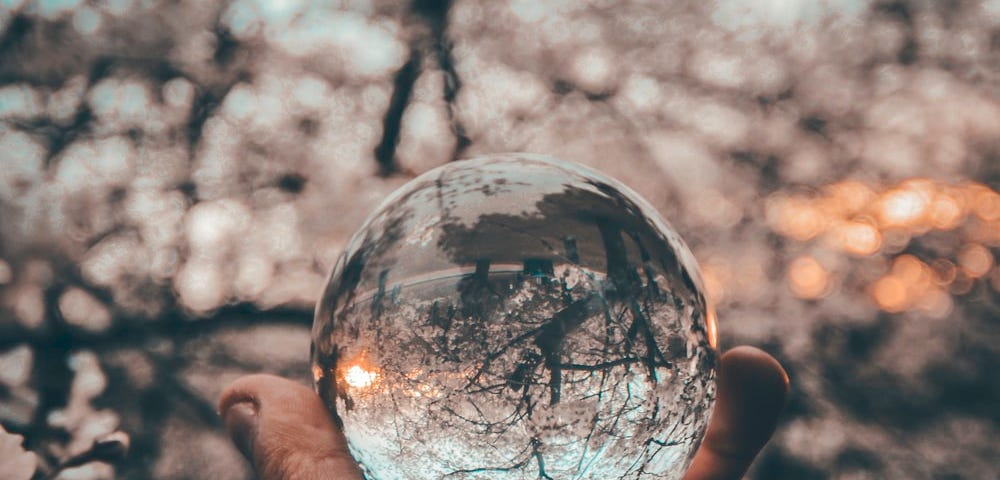 A crystal ball held in a man’s palm
