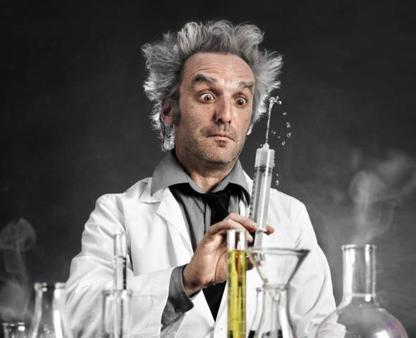 a weird scientist staring at syringe and several glass jars with unknown chemical are in front of him