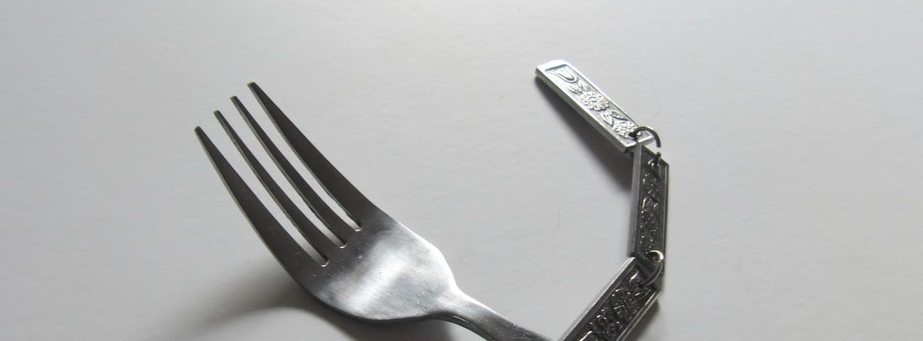 A fork with a linked decorative chain for a handle. Completely useless. Another art piece from Katerina Kamprani to symbolize the danger of a broken user experience.