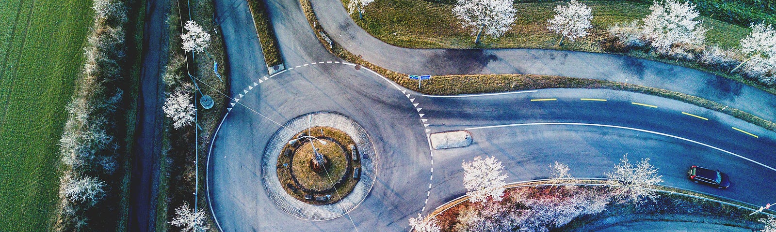 aerial view of a traffic circle with a total of three directions to choose from