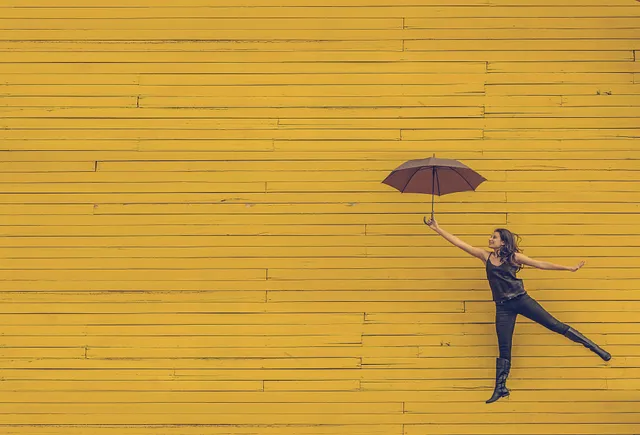 woman holding an umbrella suspended in air while providing knowledge and resources to Medium writers