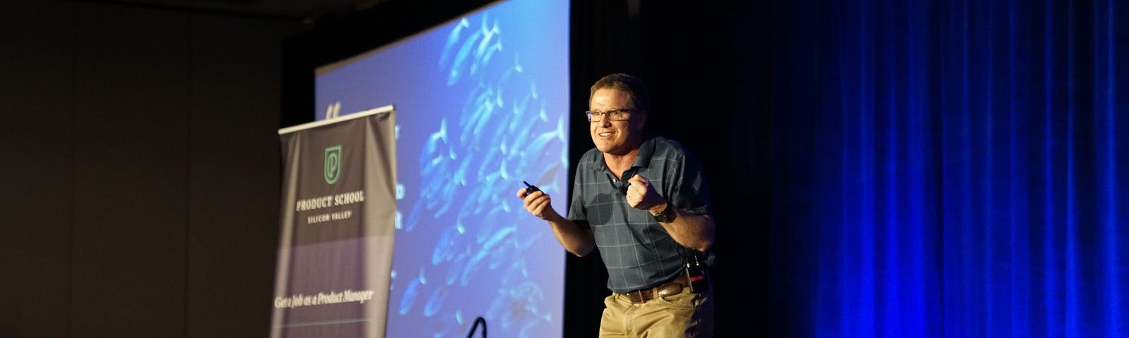 pic of a public speaker on stage- addrssing his audience