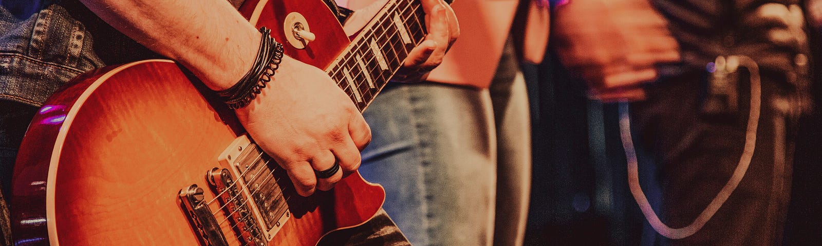 Musician playing Gibson Les Paul electric guitar