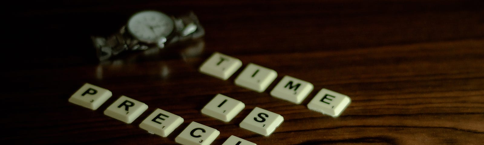 Photo of scrabble blocks spelling, “Time Is Precious”.