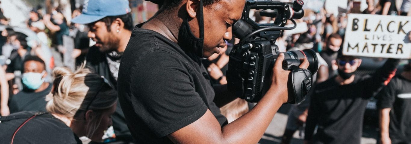 Image of a man taking pictures at a Black Lives Matter protest