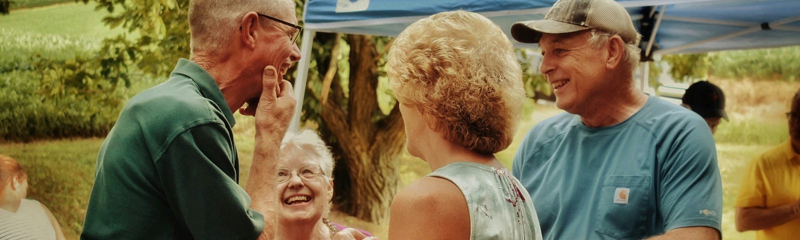 Group of older people smiling at a reunion