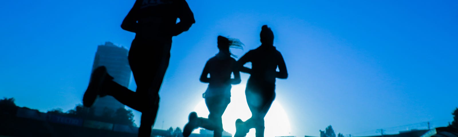 3 women running in the dark