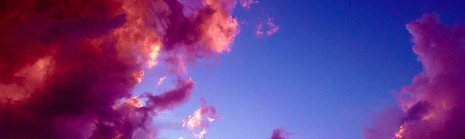 Pink and purple clouds in a blue sky