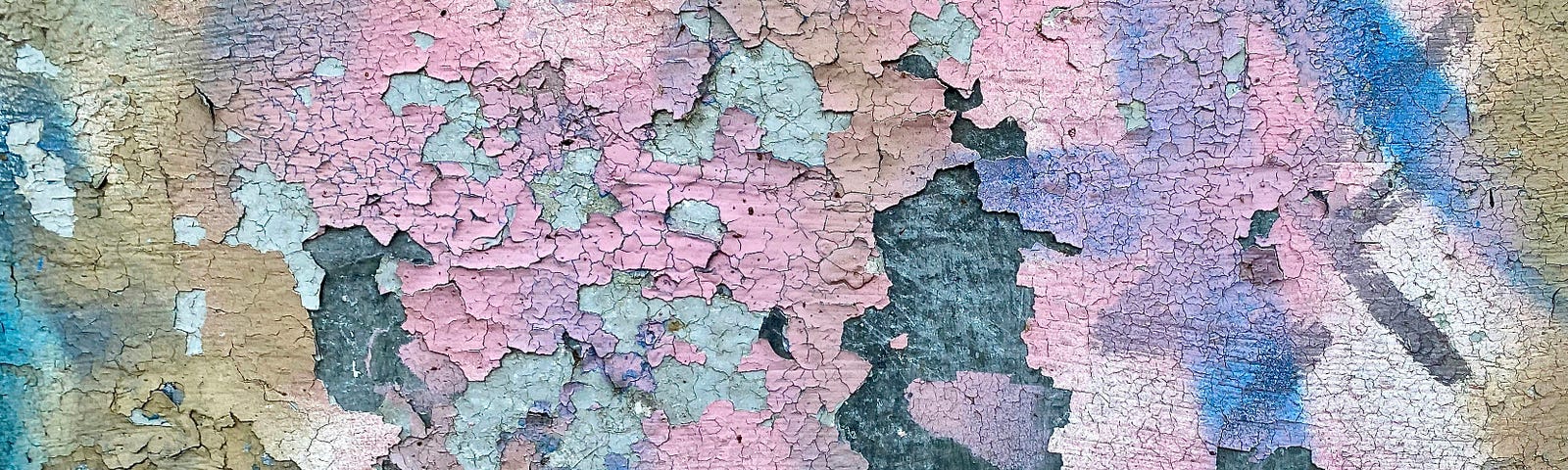 different colors of paint chipping from a wall