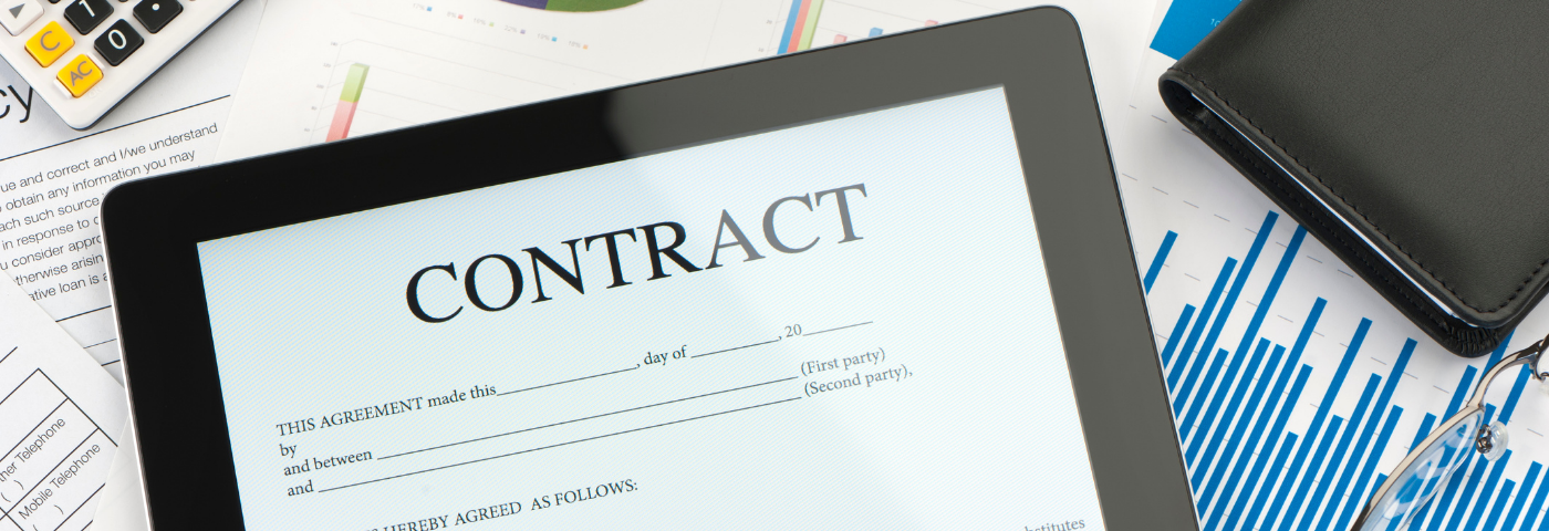 Blank contract in digital form on a tablet. Tablet on a desk with papers and a calculator.