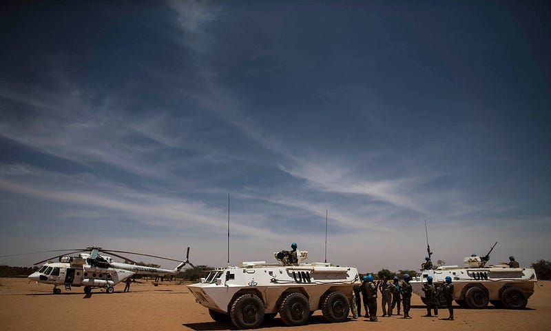 Peacekeepers from the Nigerian contingent of MINUSMA provide security on an airstrip during the arrival of a U.N. fact-finding mission in Mali.