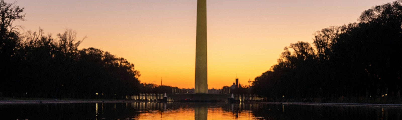 Photo by Harrison Mitchell on Unsplash of the sun setting behind the Washington Monument