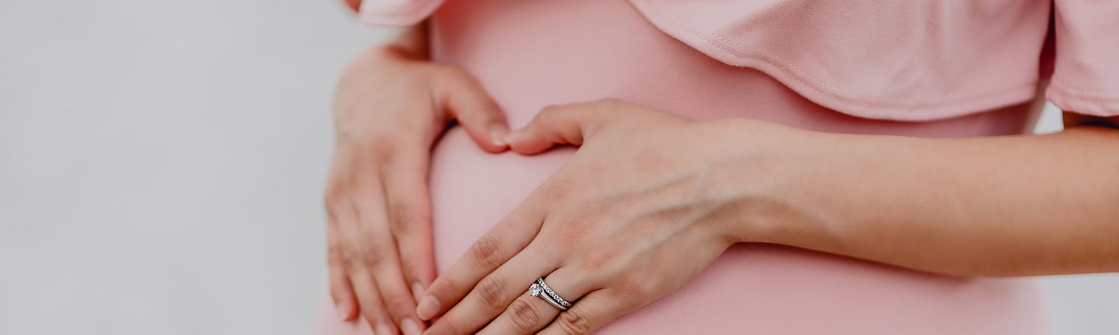Pregnant woman’s hands on her belly