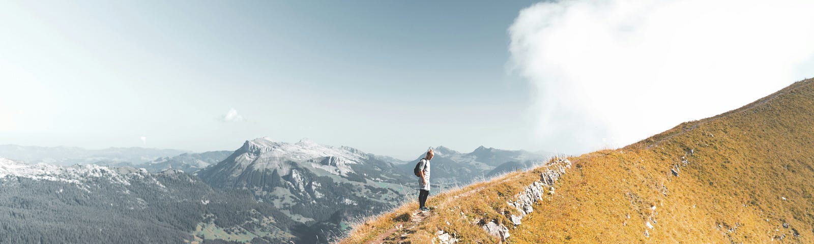Person standing on top of the mountain