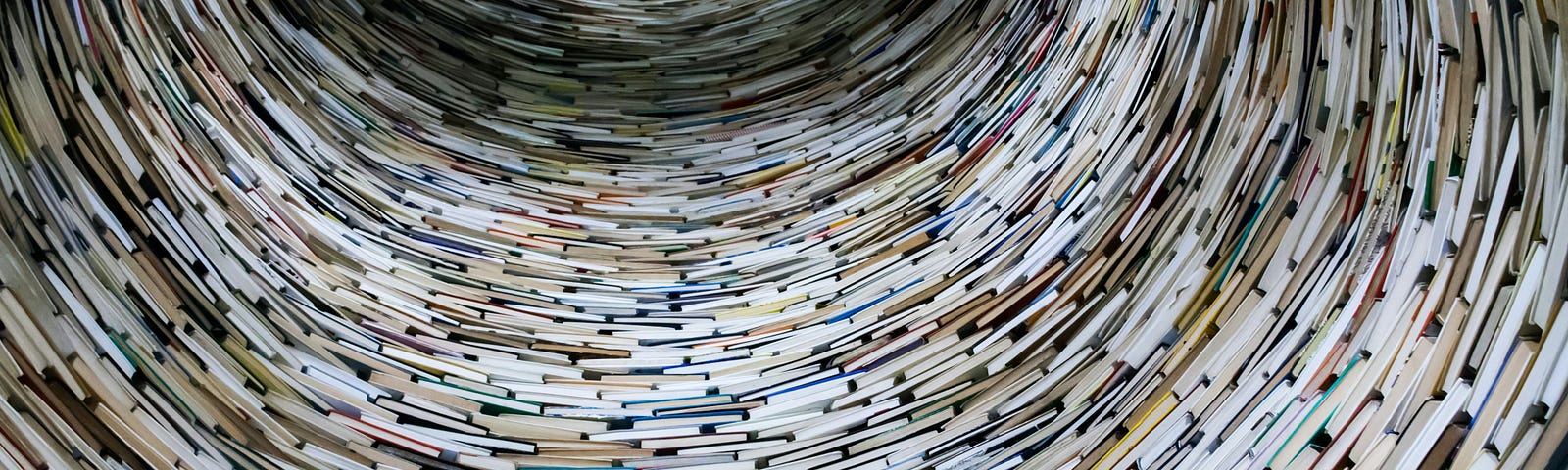 tornado-like spiral pattern of books with light at the top