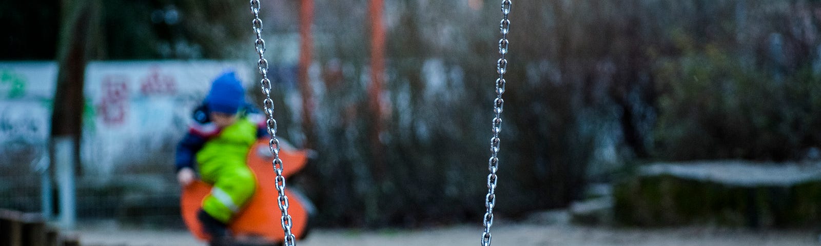 An empty swing on a playground