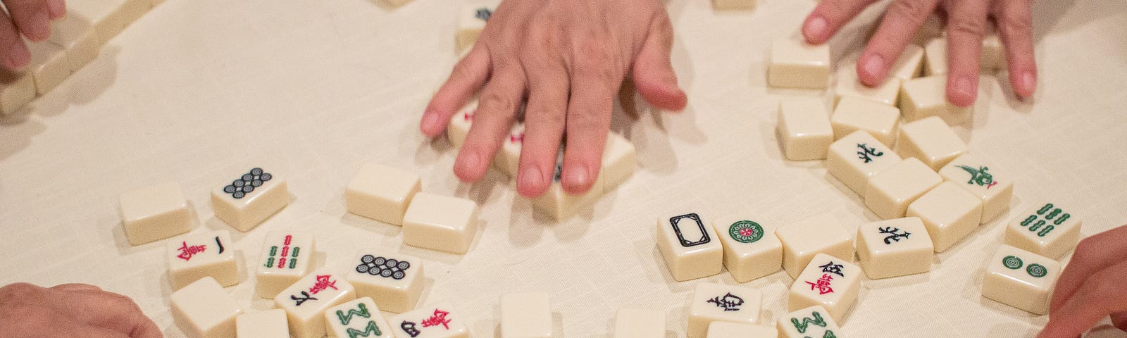 Picture of people playing a game of mahjong