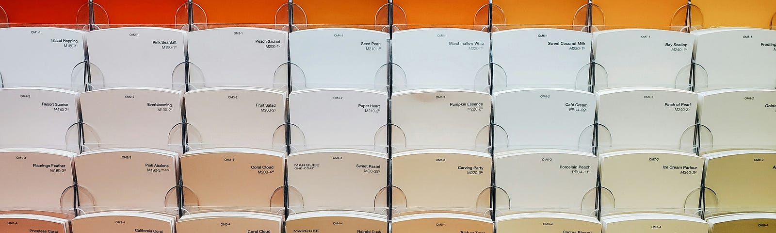 Rows of wall paint color swatches in different shades of orange. Used here to represent different vector values, and playing on the theme of matching.