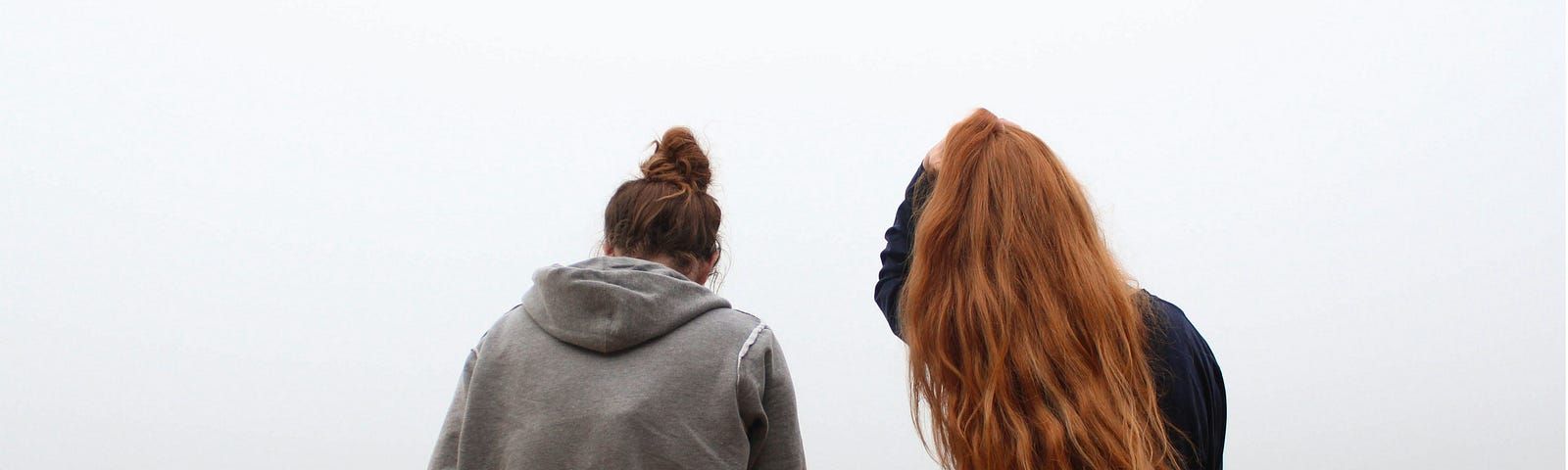 Two friends talking at the end of a dock.