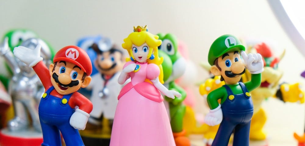 Nintendo amiibo toys of characters Mario, Luigi, and Peach. Image by Ryan Quintal on  Unsplash.