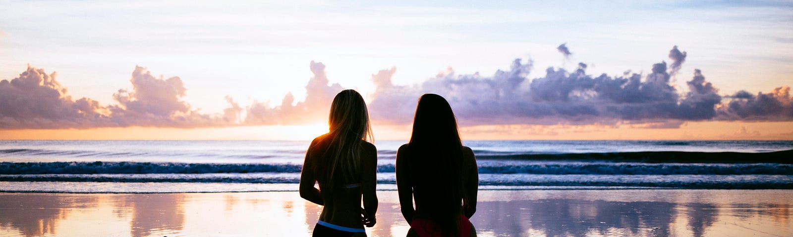 two women looking out on the beach