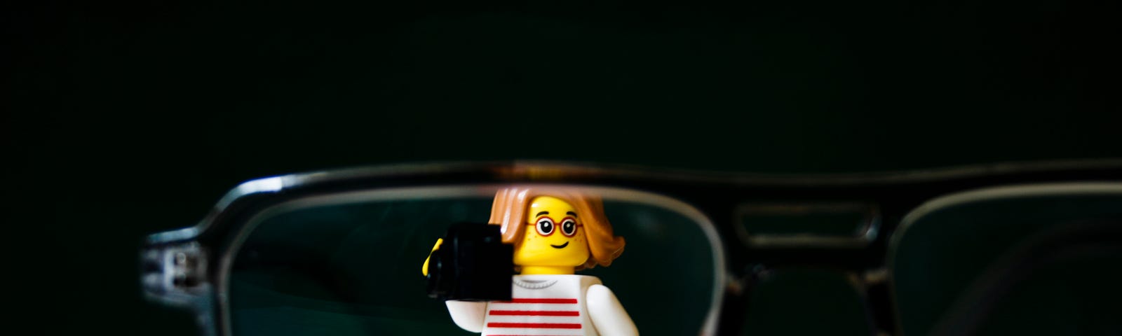 image of a lego character who is standing behind a pair of glasses
