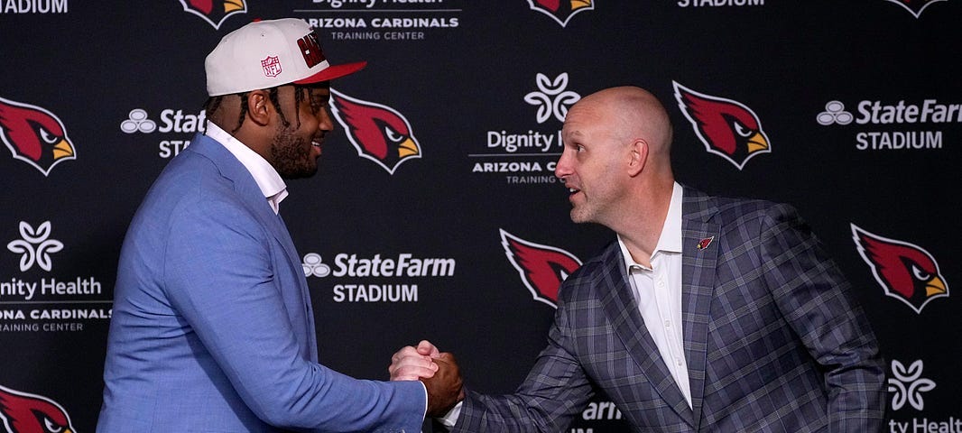 General Manager Monti Ossenfort of the Arizona Cardinals shakes hands with one of the teams selections in the 2023 NFL Draft