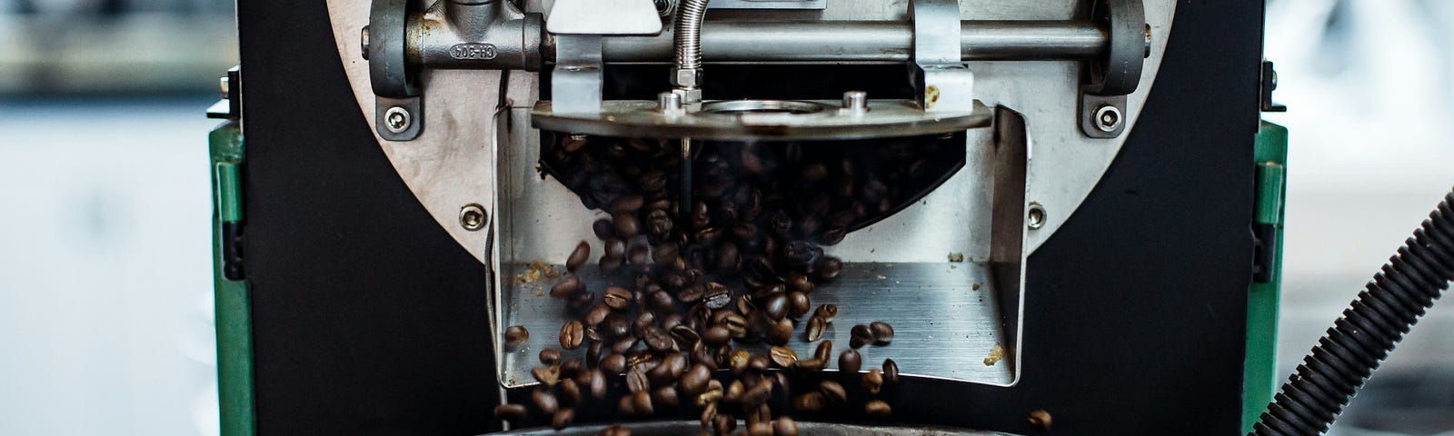 Coffee beans falling into a grinder
