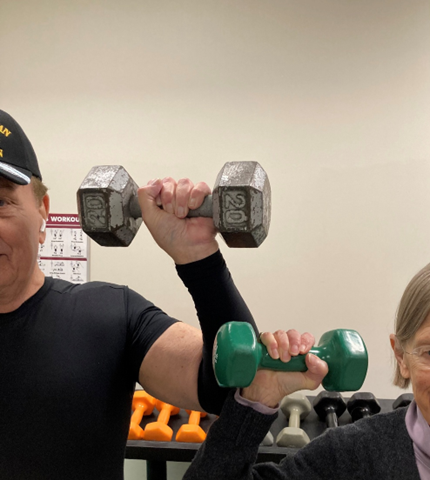 Man and woman holding dumbbells