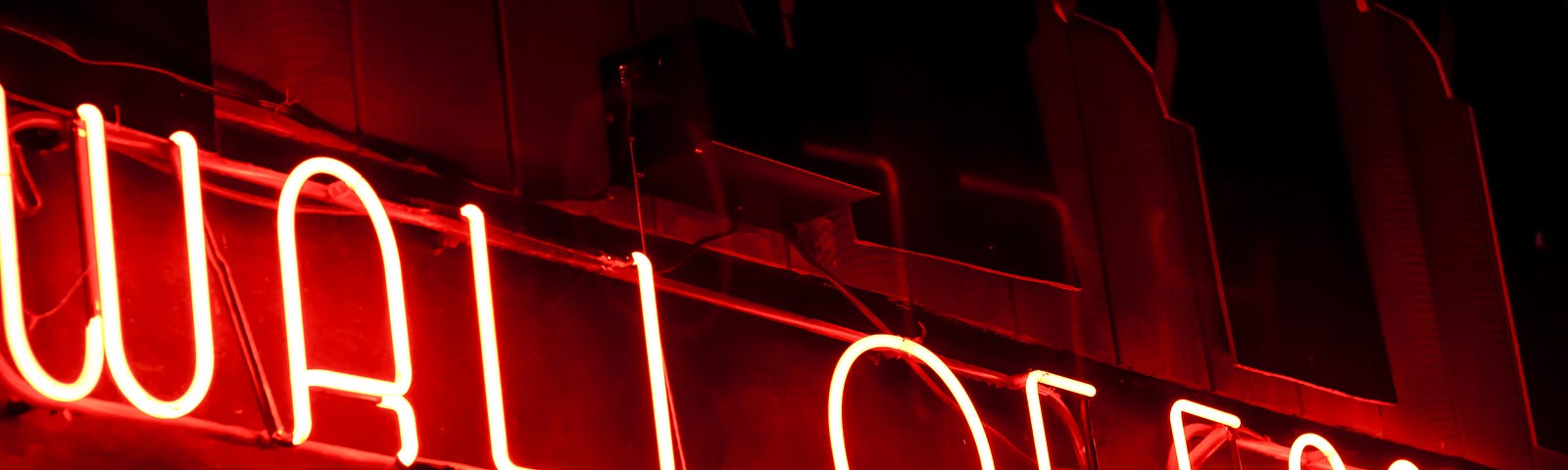 neon sign at night saying WALL OF FAME in red letters