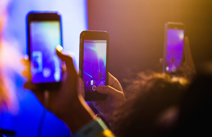 People on phones at concert