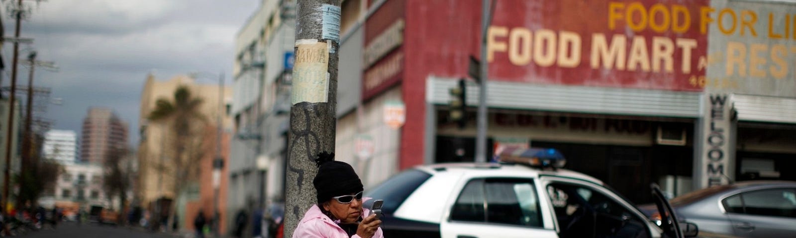 A woman uses a cell phone on downtown Los Angeles’ Skid Row, March 6, 2013. Photo by Lucy Nicholson/Reuters