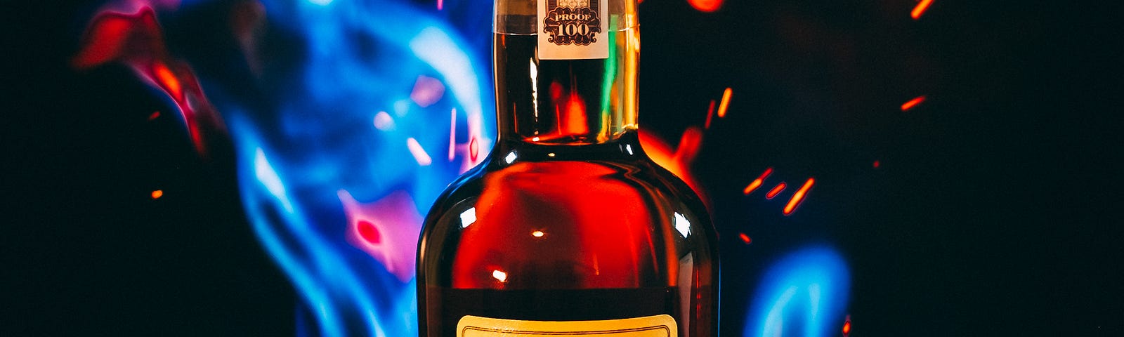 A bottle of Taylor single malt whiskey stands in the image center, surroundied by blue flames.