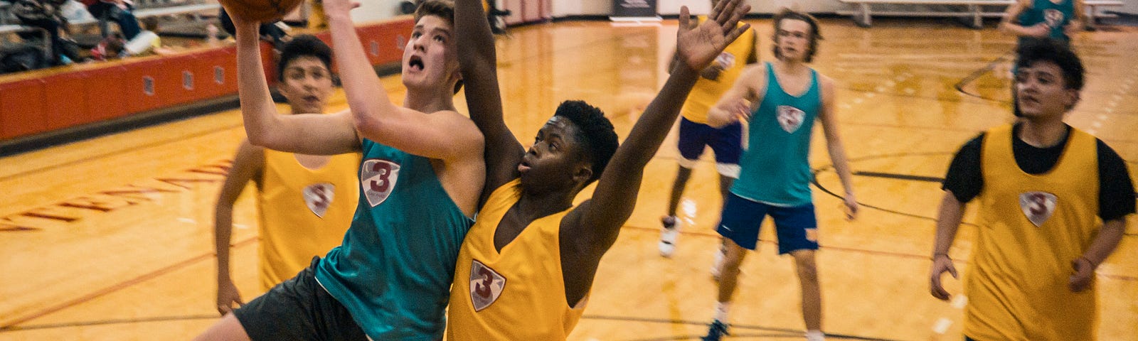 High School Basketball Players jostling for the ball.