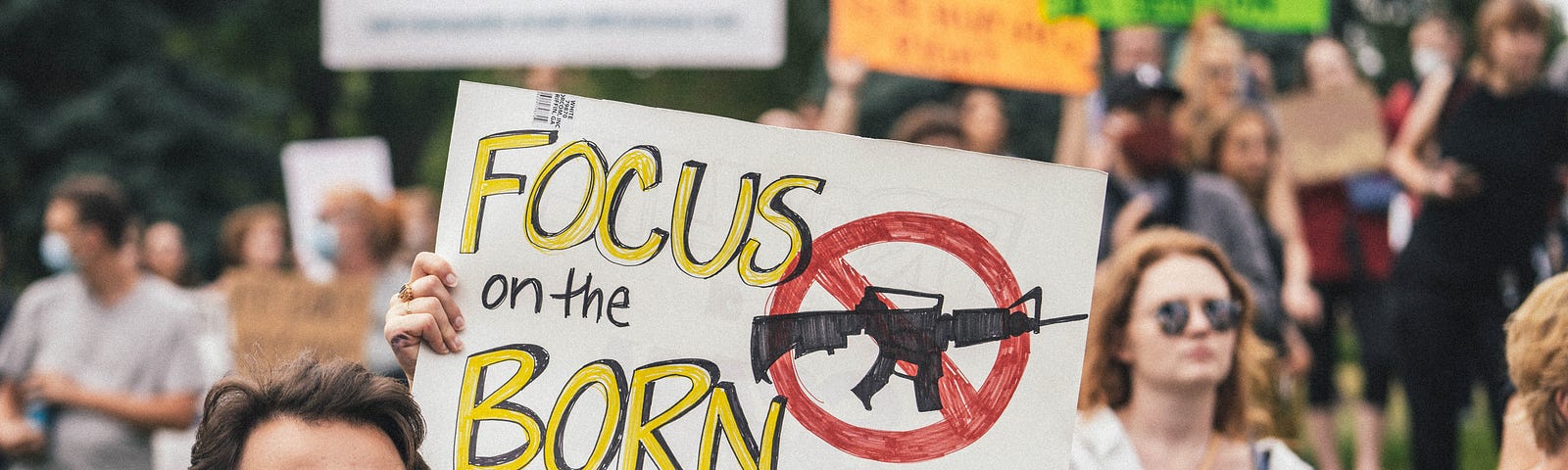 protest sign “focus on the born”