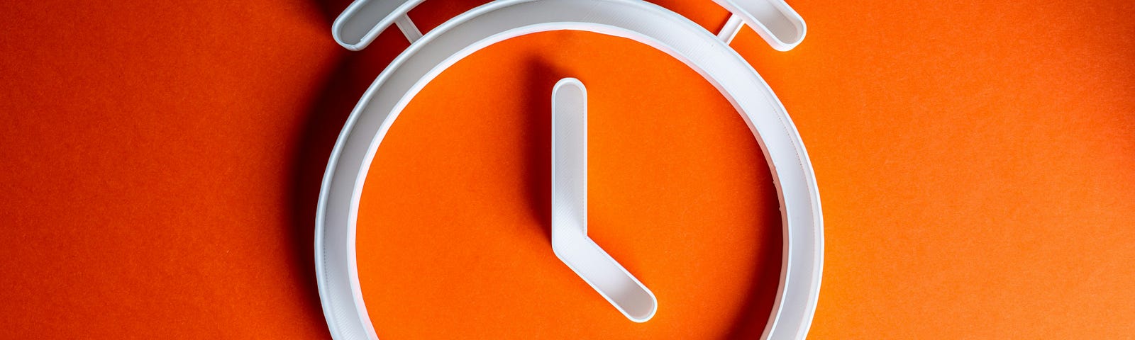 Image of a large clock with a red background.