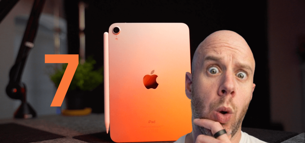 Mark Ellis with his hand in his chin looking awed. Behind is an orange iPad Mini 6. To the left of it is ‘7’.