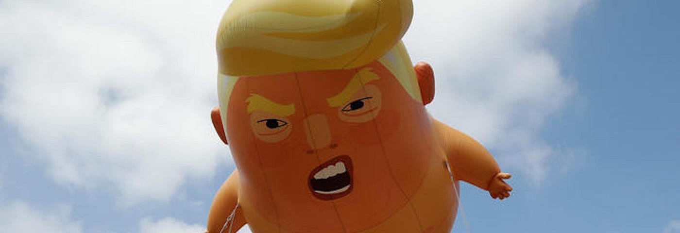 Photo of Trump blimp balloon. Parades. Donald Trump. Thanksgiving Day. New York City. Satire. Humor. Funny.