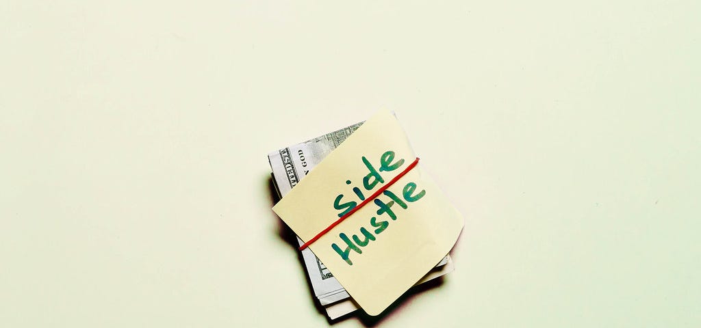 A news paper folded with the caption “side hustle “ written on it
