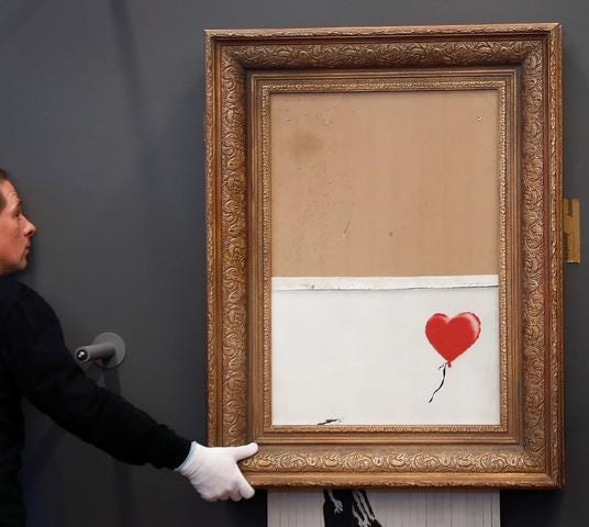 An image of Banksy’s photograph being shredded