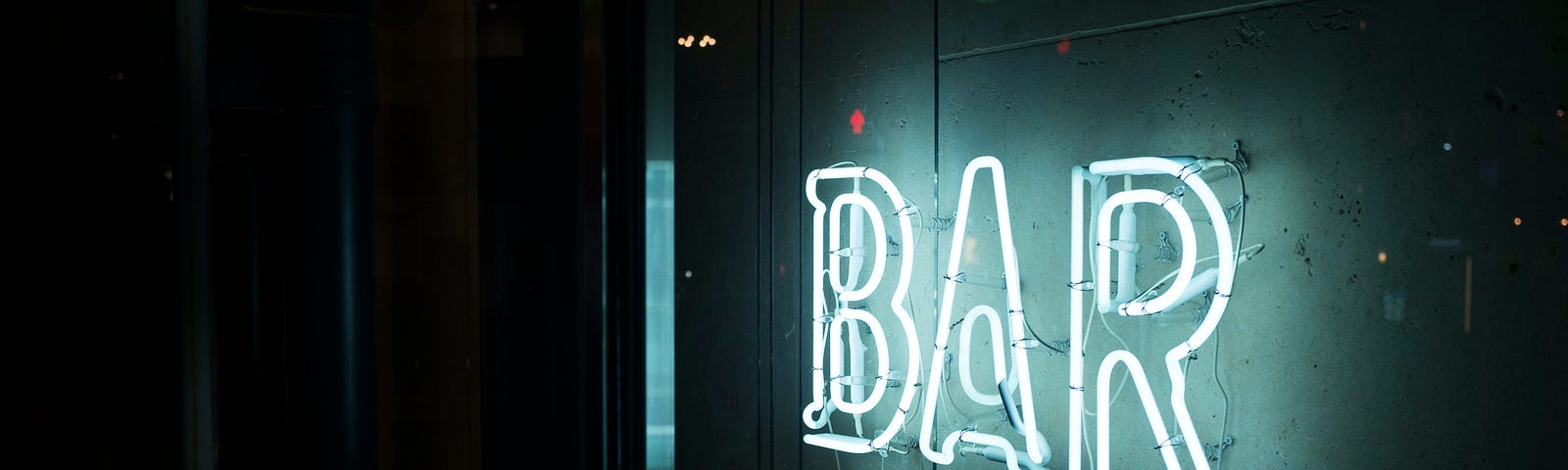 A neon sign saying ‘bar”.