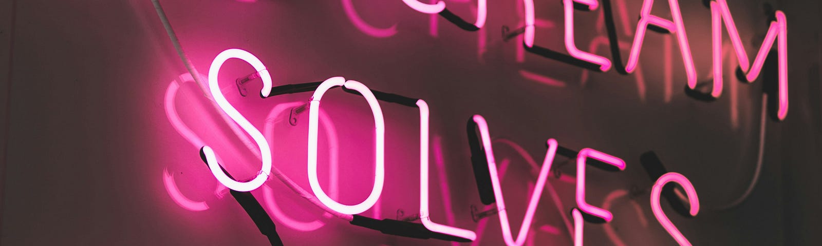 Pink neon sign saying ‘Ice-cream solves everything’