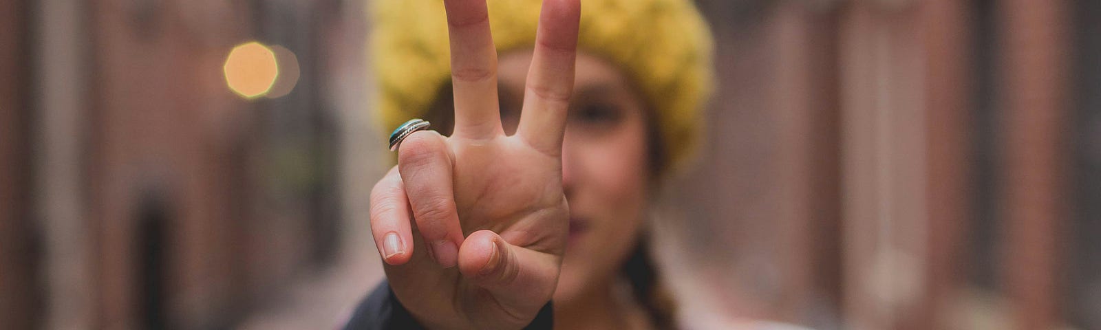 woman with peace sign close up