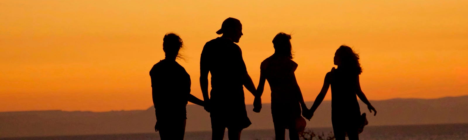 Photo of a family at sunset via Alt text on Medium