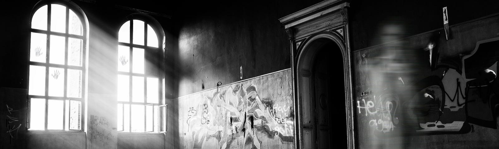 A black-and-white picture of a ghastly figure inside an abandoned building.