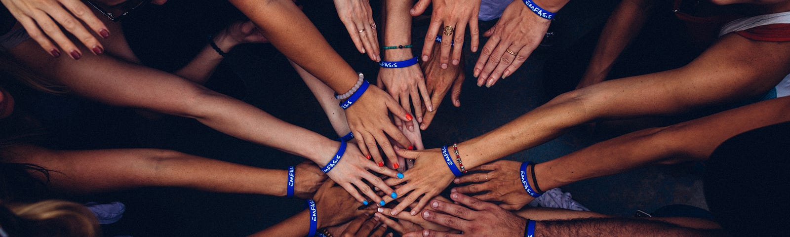 An image in which people are joining each others hand representing collaboration